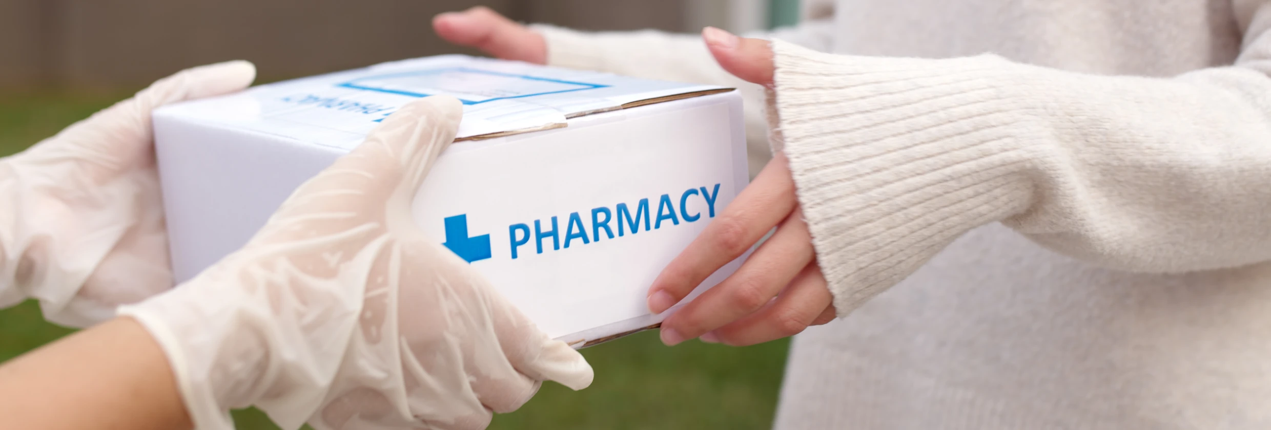 Hands exchanging pharmacy package