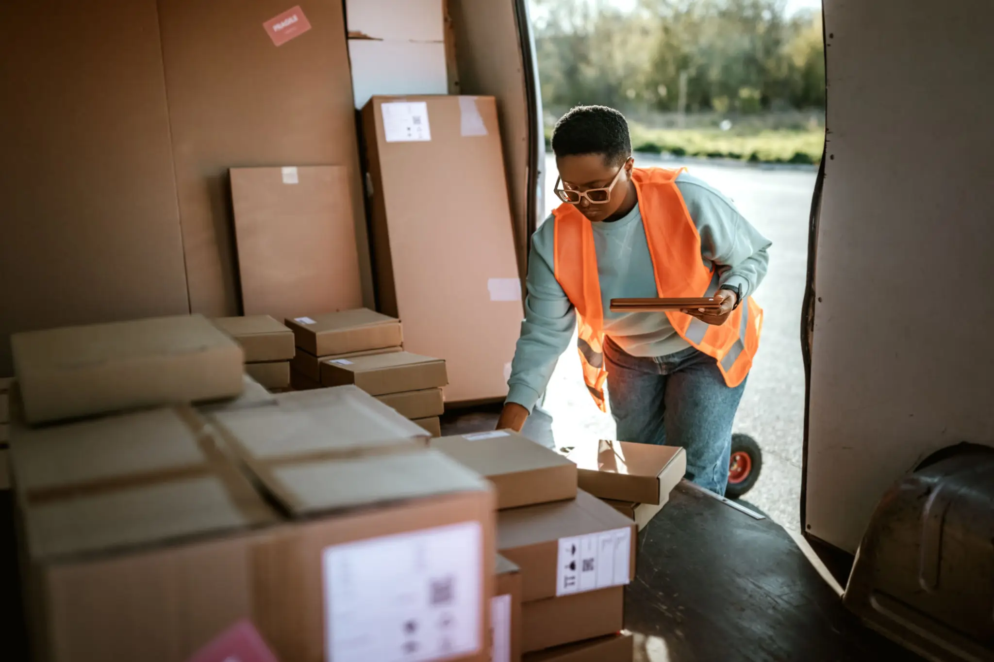 Worker checking packages in a warehouse.